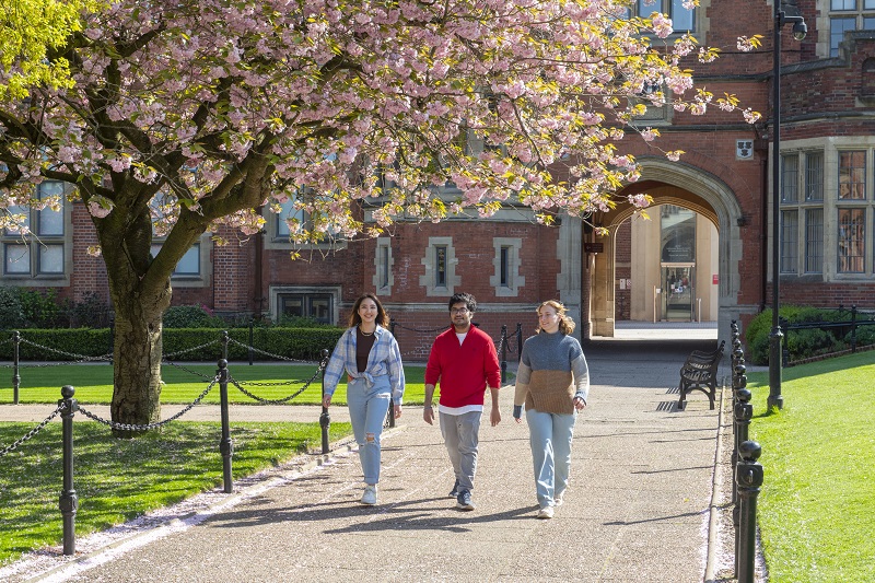 students in quad with cherry blossom