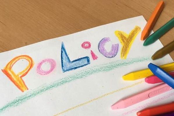 Colourful crayon drawing of the word Policy