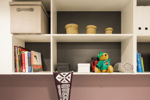 Shelves with mementos and books in student accommodation room