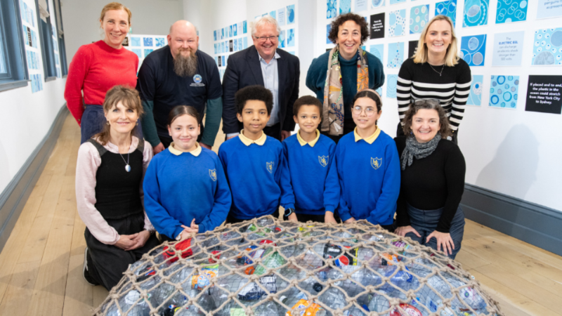 Children and staff with net full of plastics