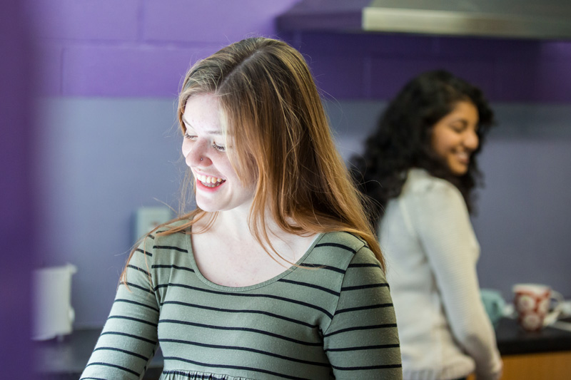 Two female students preparing food in a kitchen in Queen's student accommodation