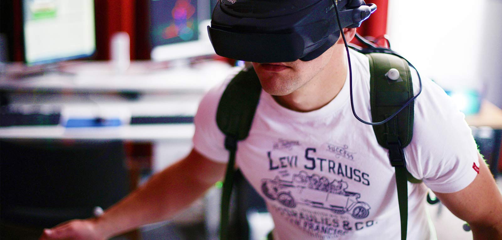 Student in t-shirt using a virtual reality rig