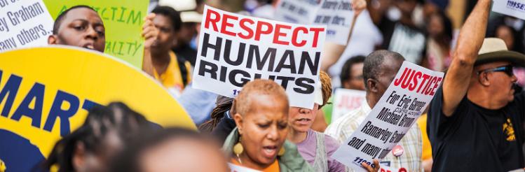 Protestors holding signs and protesting for human rights