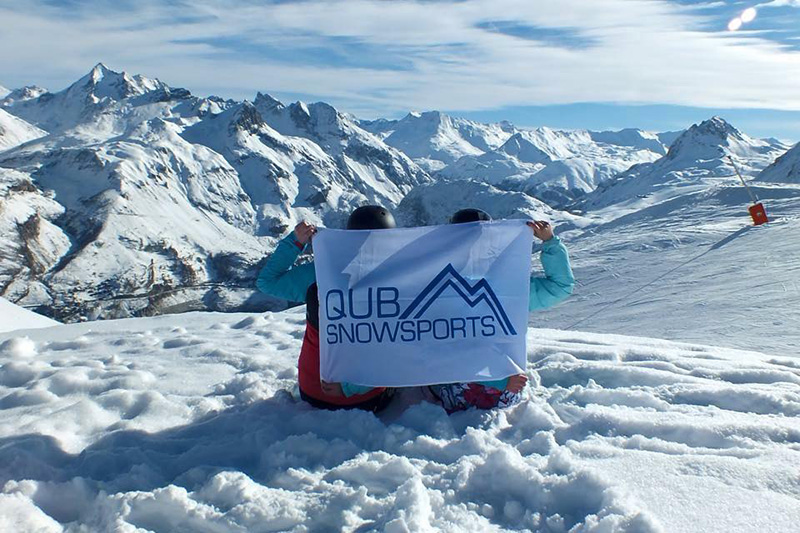 QUB-Snowsports flag on a snowy mountain