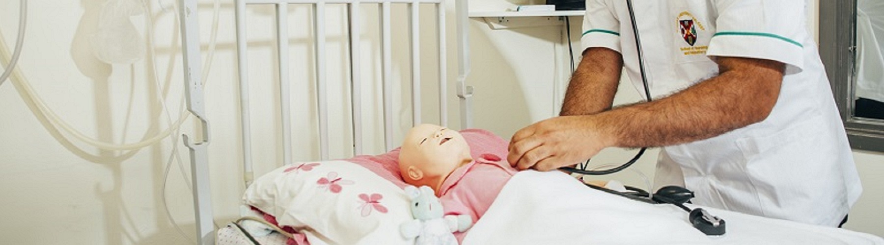 Nurse practicing on a fake baby