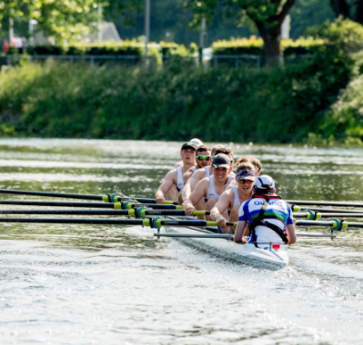 Students rowing down a river in the sun