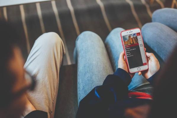 Students looking at Queen's Online on mobile phones