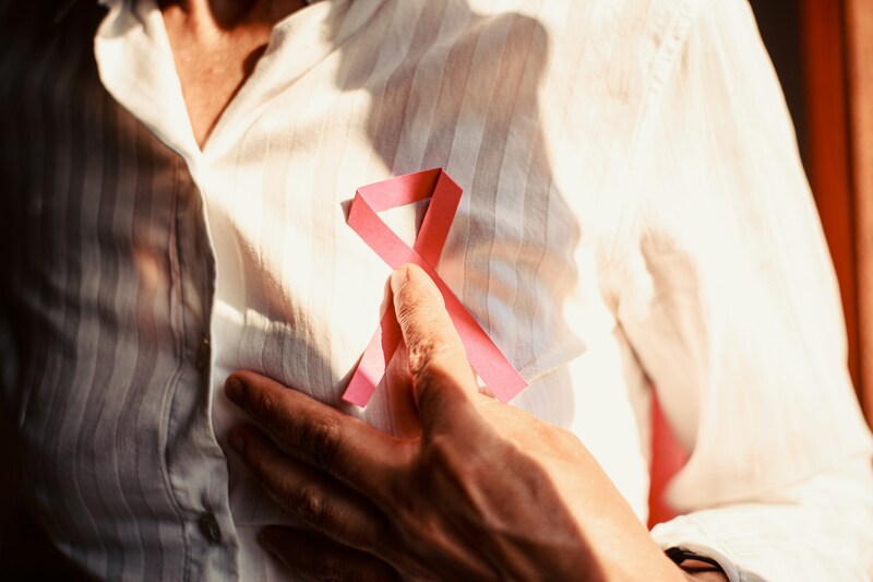 Breast cancer ribbon on woman's chest