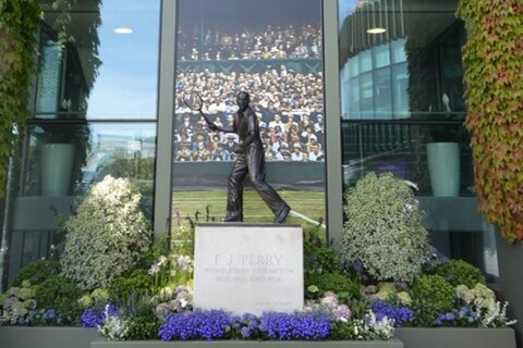 Wimbledon statue in front of Centre Court sign