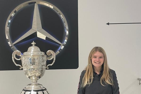 Student Charlotte with F1 trophy