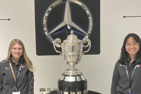 Charlotte Jennings and colleague next F1 trophy