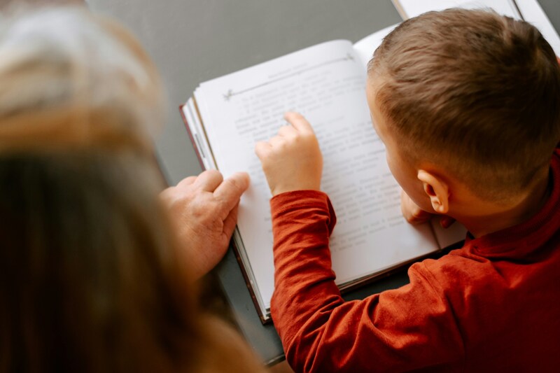 Adult teaching child how to read