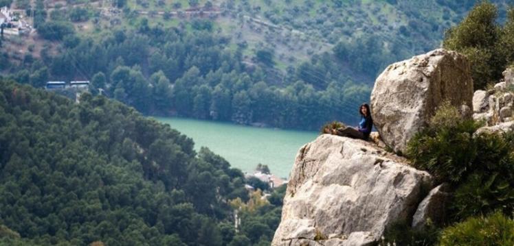 Student from Queen's Mountaineering club at El Chorro Trip sitting on cliff edge