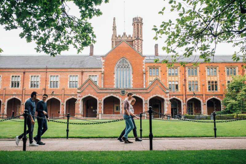 Four students walking through the Quad