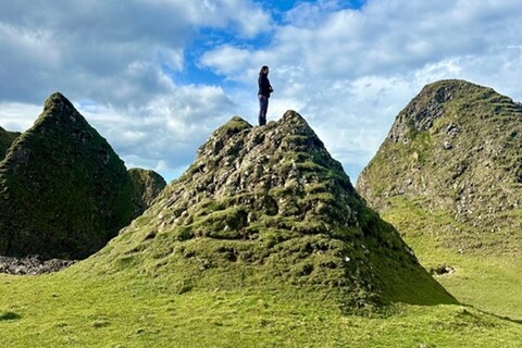 Student on top of hill at Ballintoy Harbour