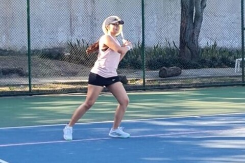 Student playing tennis