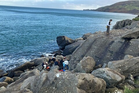 Students sitting on Jailhouse Rock at Fair Head