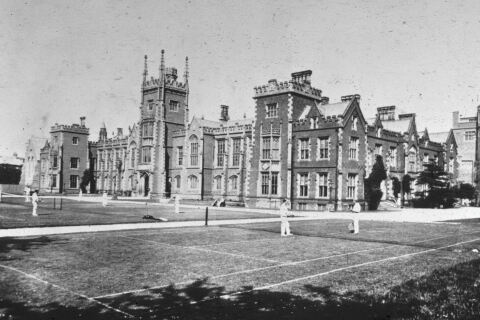 Students playing tennis on lawn in front of Lanyon circa 1920s