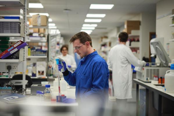 Man in a blue coat in the lab