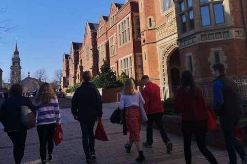 Queen's student ambassador taking a group tour of the campus