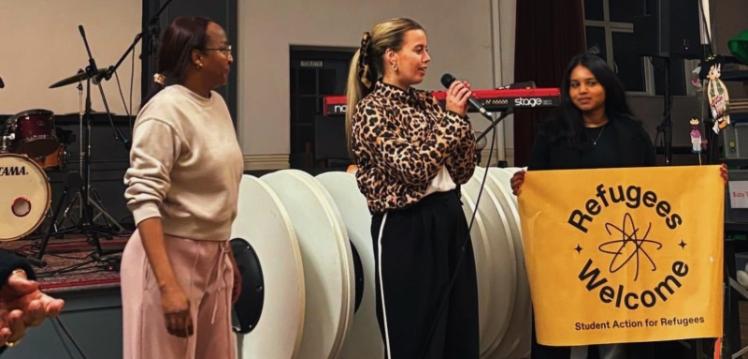 Student Ornait speaking at STAR event alongside two female students