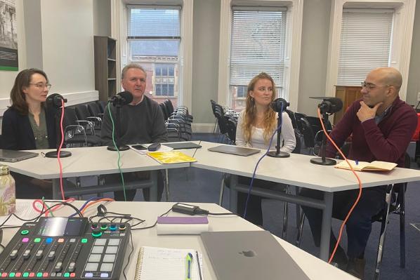 Four staff members in podcast setting