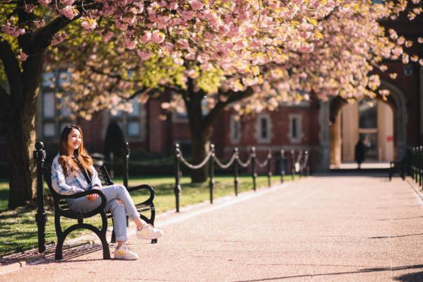 Student sitting in the Quad in Spring