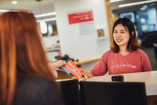 Student receiving pocket guide