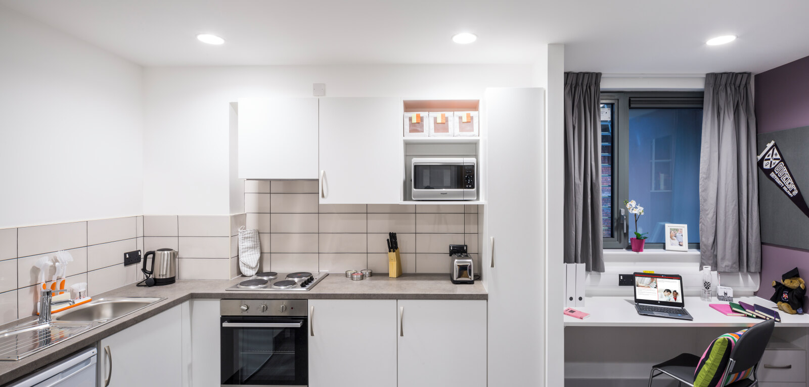 Queen's accommodation kitchen and desk