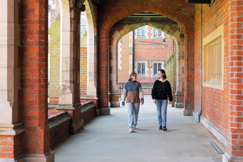 Two students walking through the Quad