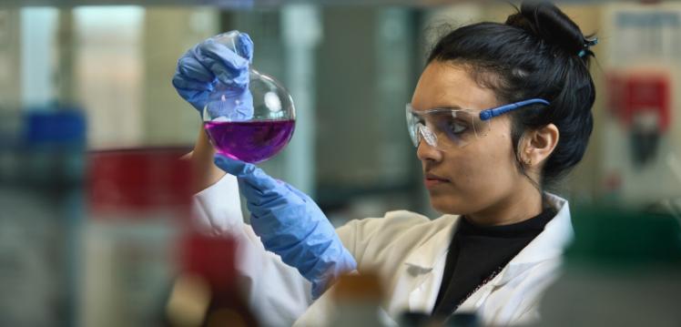 Researcher reviews chemicals in a lab