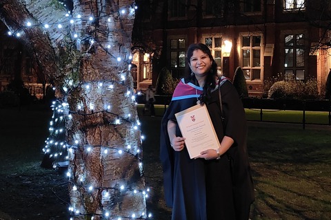 Student Sai Sree with her degree in the Quad