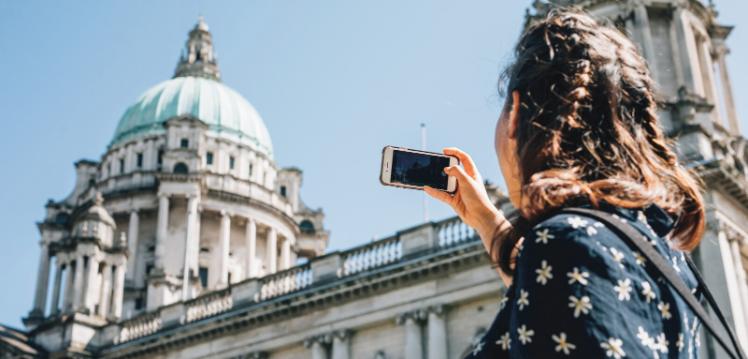 Student taking photo of Belfast city hall