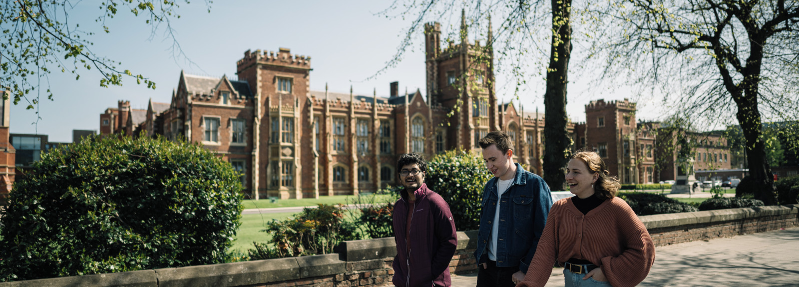 Group of students walking past the front of the Lanyon