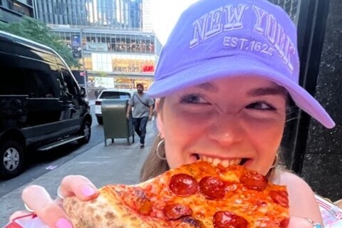 Student eating pizza in New York