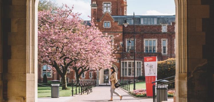 Student walking through the Quad in spring