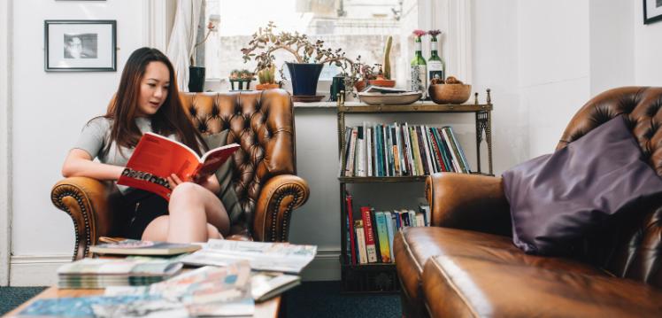 Student reading book in office