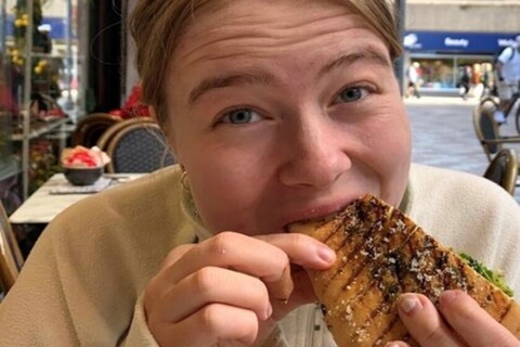 Student eating sandwich from Sawers