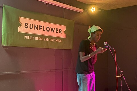 Student speaking at open mic event in the Sunflower