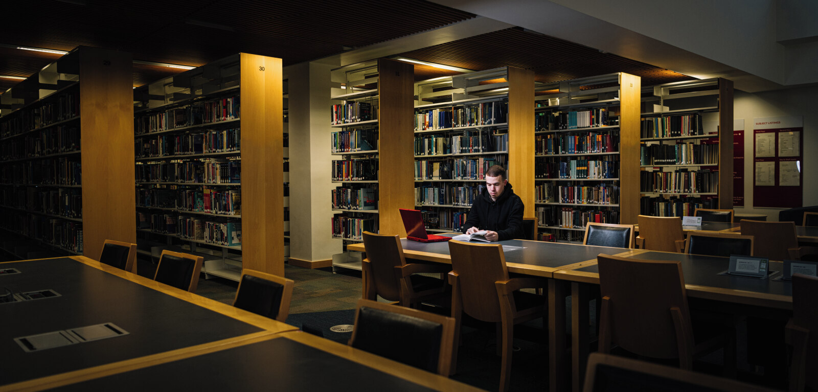 Student studying on table in McClay Library