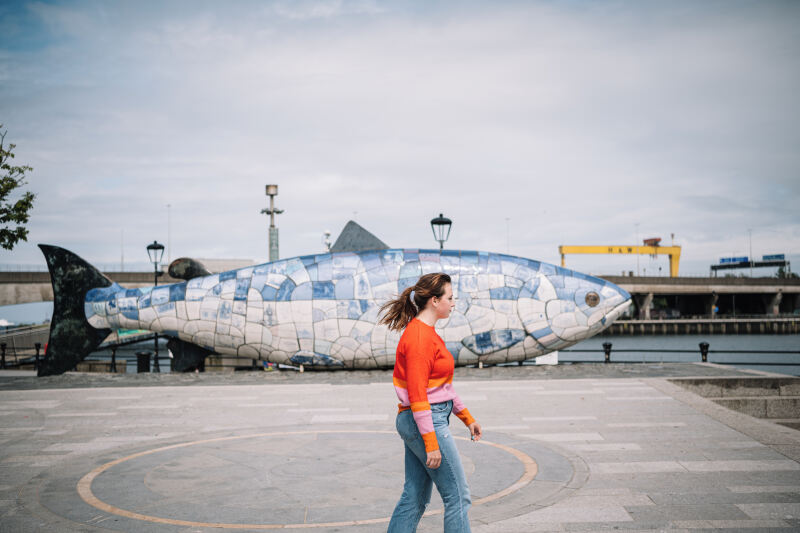 Student walking past the big fish