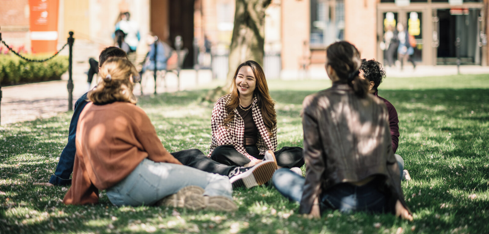 Group of students sitting on the grass in the quad