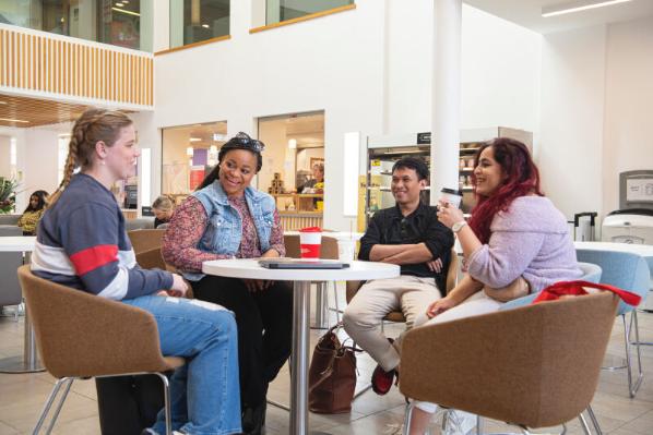 Group of four students having coffee in Junction Cafe