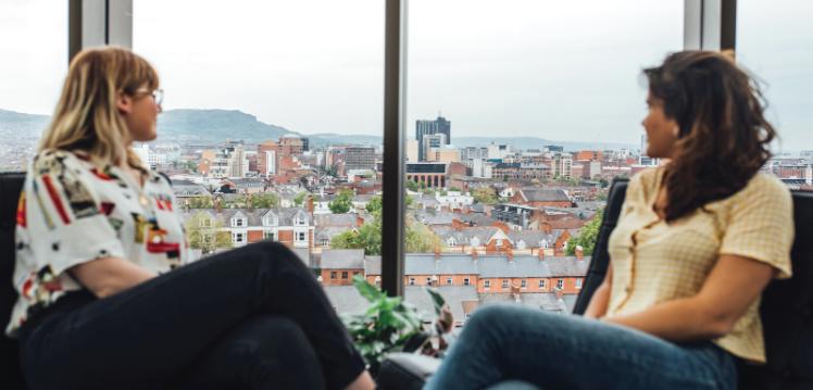 Two students looking out window