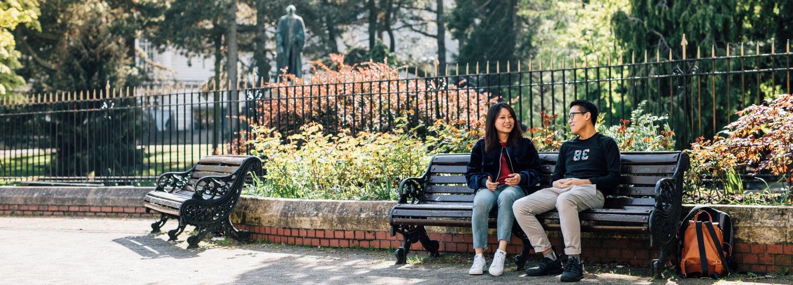 Two students sitting on bench in Botanic Gardens