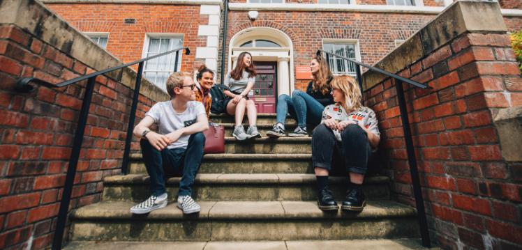 Group of students on steps on Queen's campus