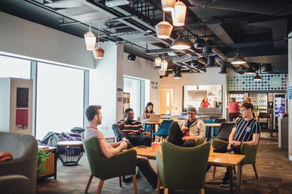 Students sitting together in seating area in accommodation