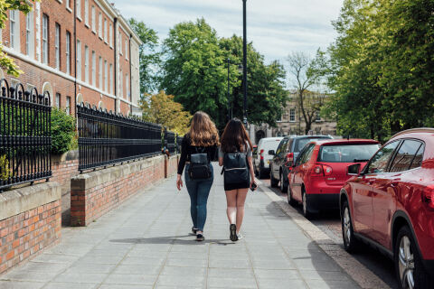 Two students walking through campus