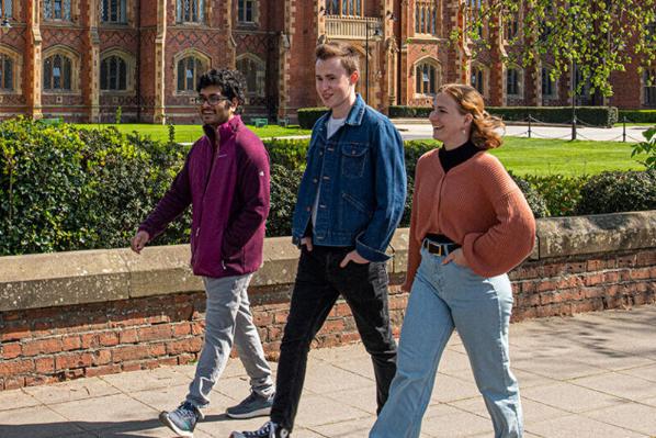 Three students walking past the Lanyon