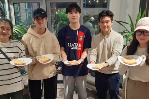 Students at Elms accommodation holding toasties